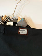 Black polo shirt with BURBERRY logo patch on chest