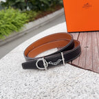 Hermes belt with dark navy leather strap, orange-brown reverse, silver buckle