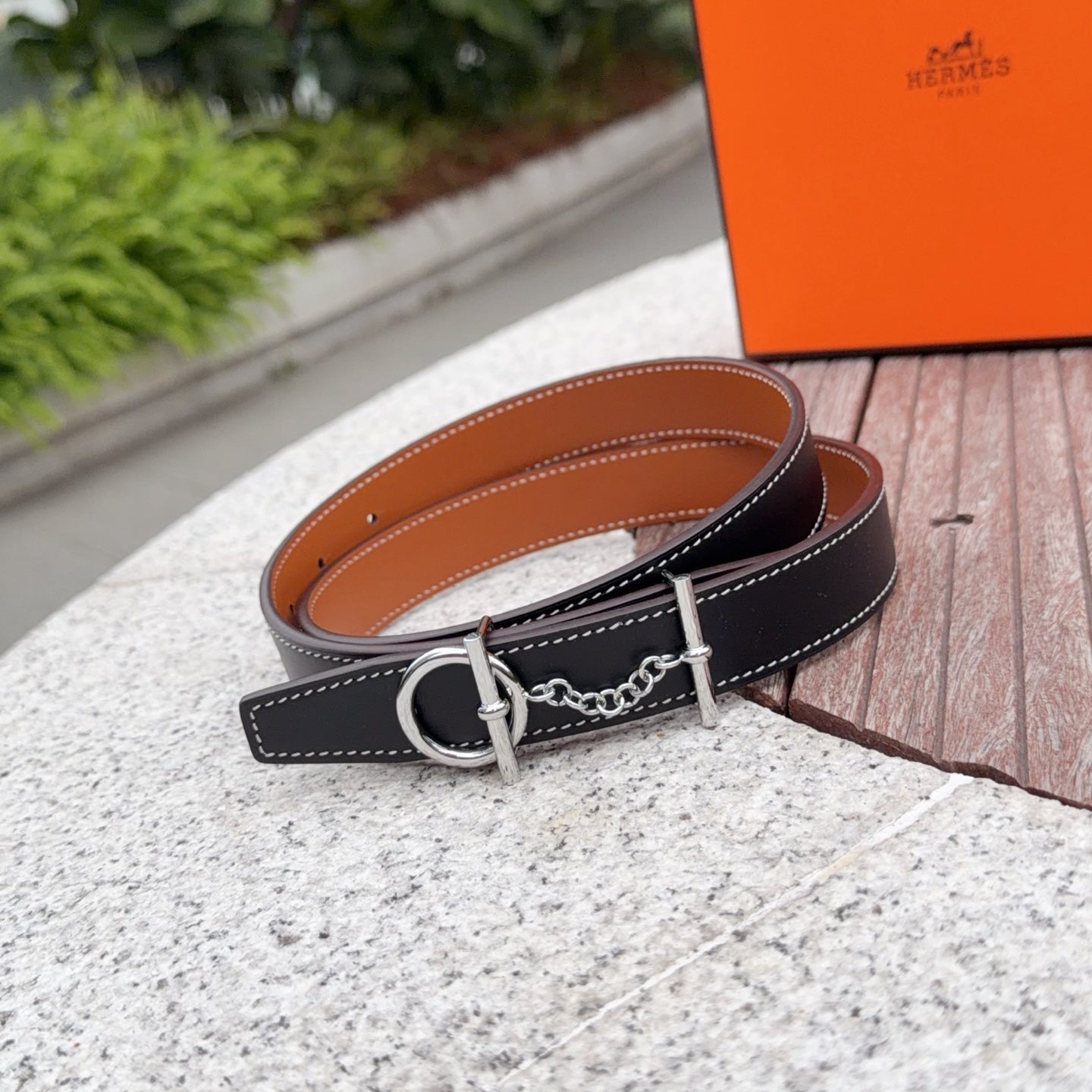 Hermes belt with dark navy leather strap, orange-brown reverse, silver buckle