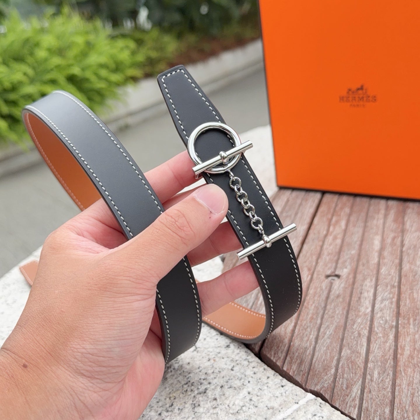 Hermes belt with dark navy leather and tan underside, silver buckle hardware