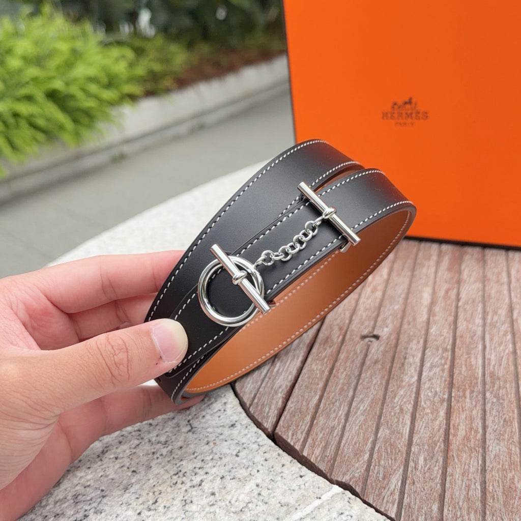 Hermes belt end with dark navy strap, silver buckle ring and chain