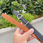 Hermes belt set: dark navy and tan leather straps with silver buckle and chain