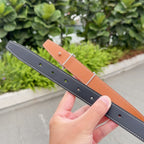 Hermes belt with dark navy and tan leather, silver buckle rings and eyelets