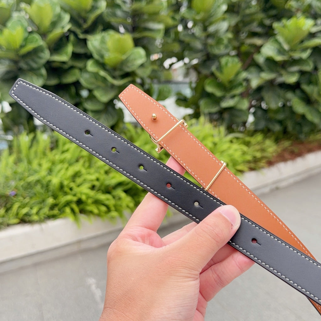 Hermes belt close-up of punched holes on dark navy strap with tan segment