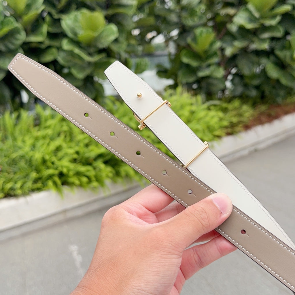 Hermes belt underside with white keeper and taupe strap holes, gold hardware
