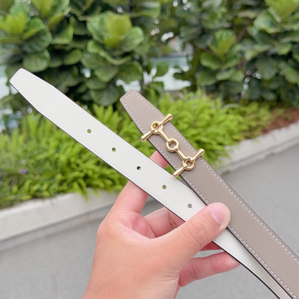 Taupe leather belt with gold buckle; white reverse side visible