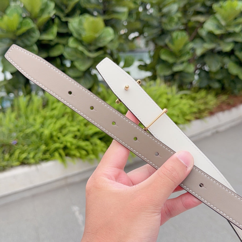 Taupe leather belt with gold buckle; punched holes on strap