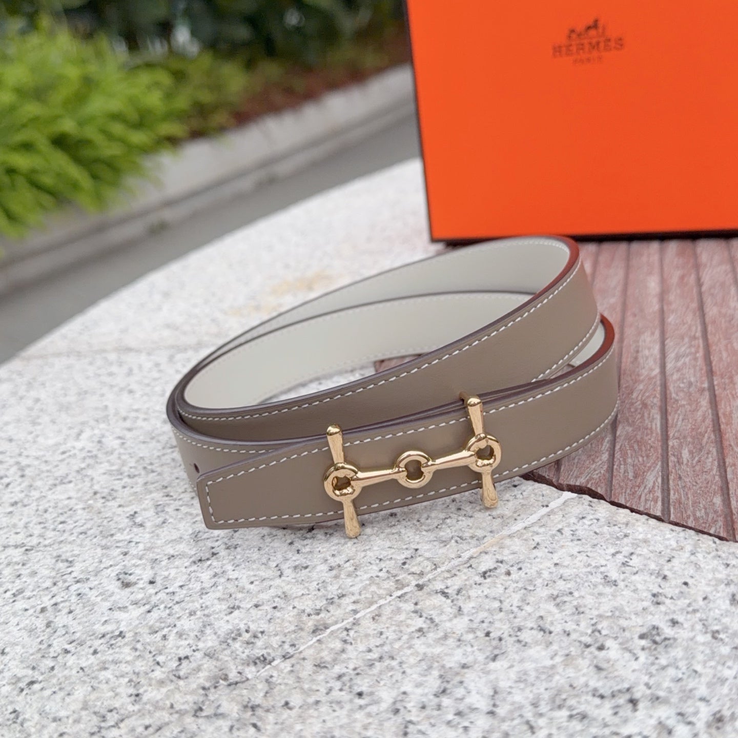 Taupe leather belt with gold buckle detail and stitched edge