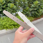 Hermes belt with light tan leather strap, visible rows of adjustment holes in close-up