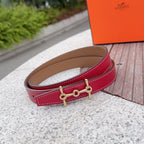 Hermes leather belt, red strap with tan back and gold-tone buckle links.