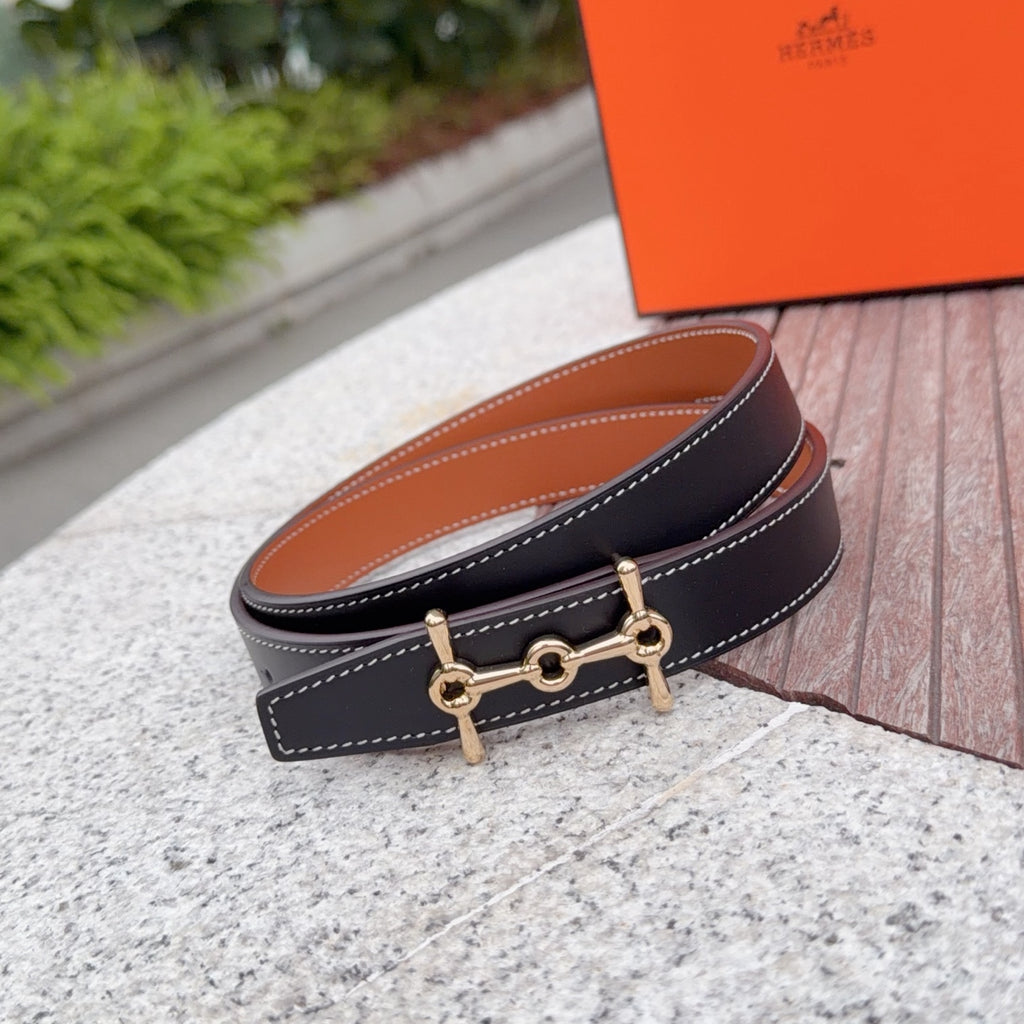 Hermes navy leather belt with gold-tone buckle and stitched strap, angled view