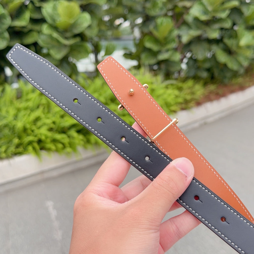 Two Hermes leather belts in gray and caramel with punched holes and topstitching