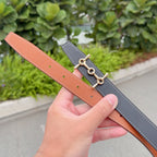 Two Hermes leather belts: caramel and gray, each with gold-tone buckle detail