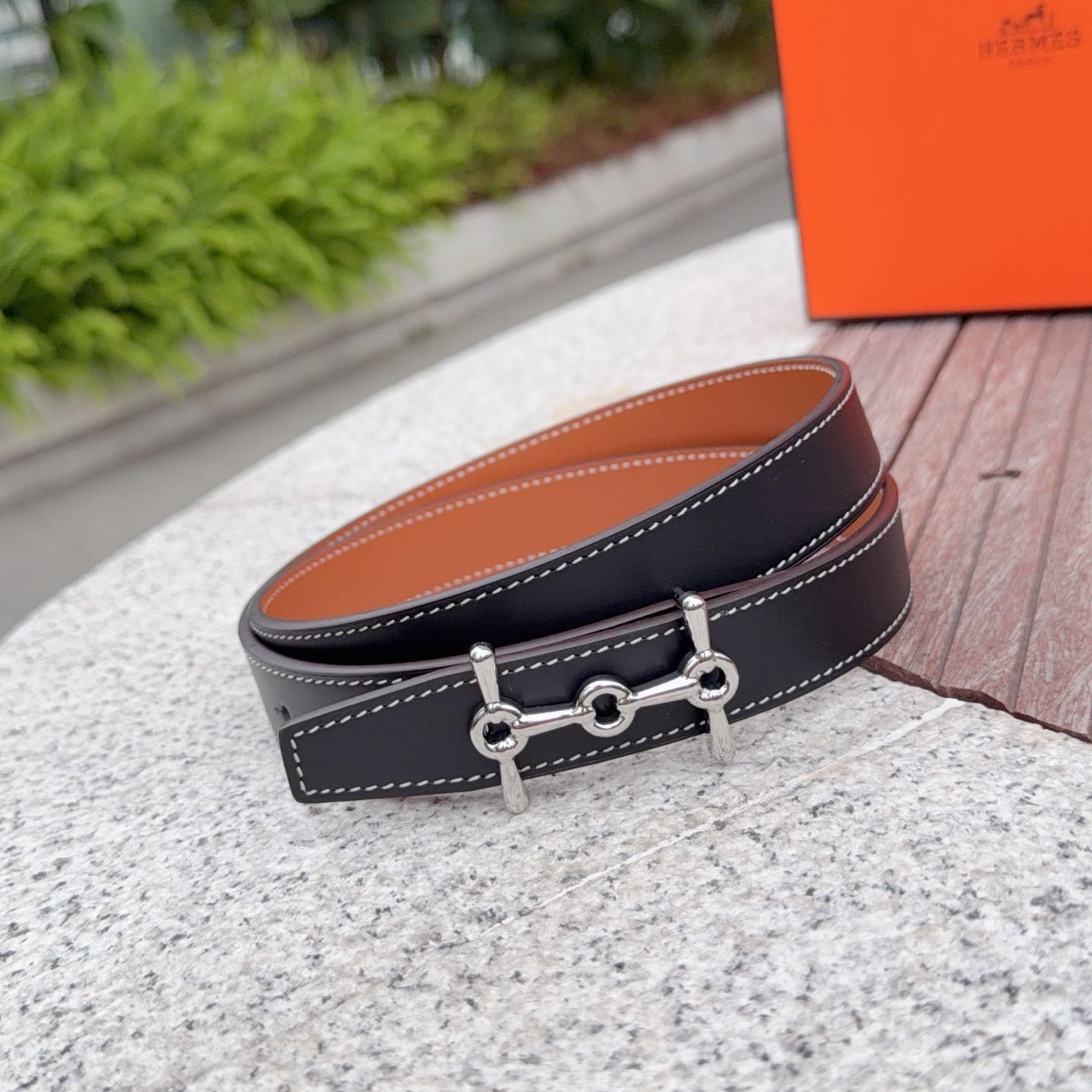 Hermes belt, dark leather with tan lining and silver buckle, double-stitch trim.