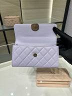 Lavender quilted mini handbag with front flap closure and small front pocket