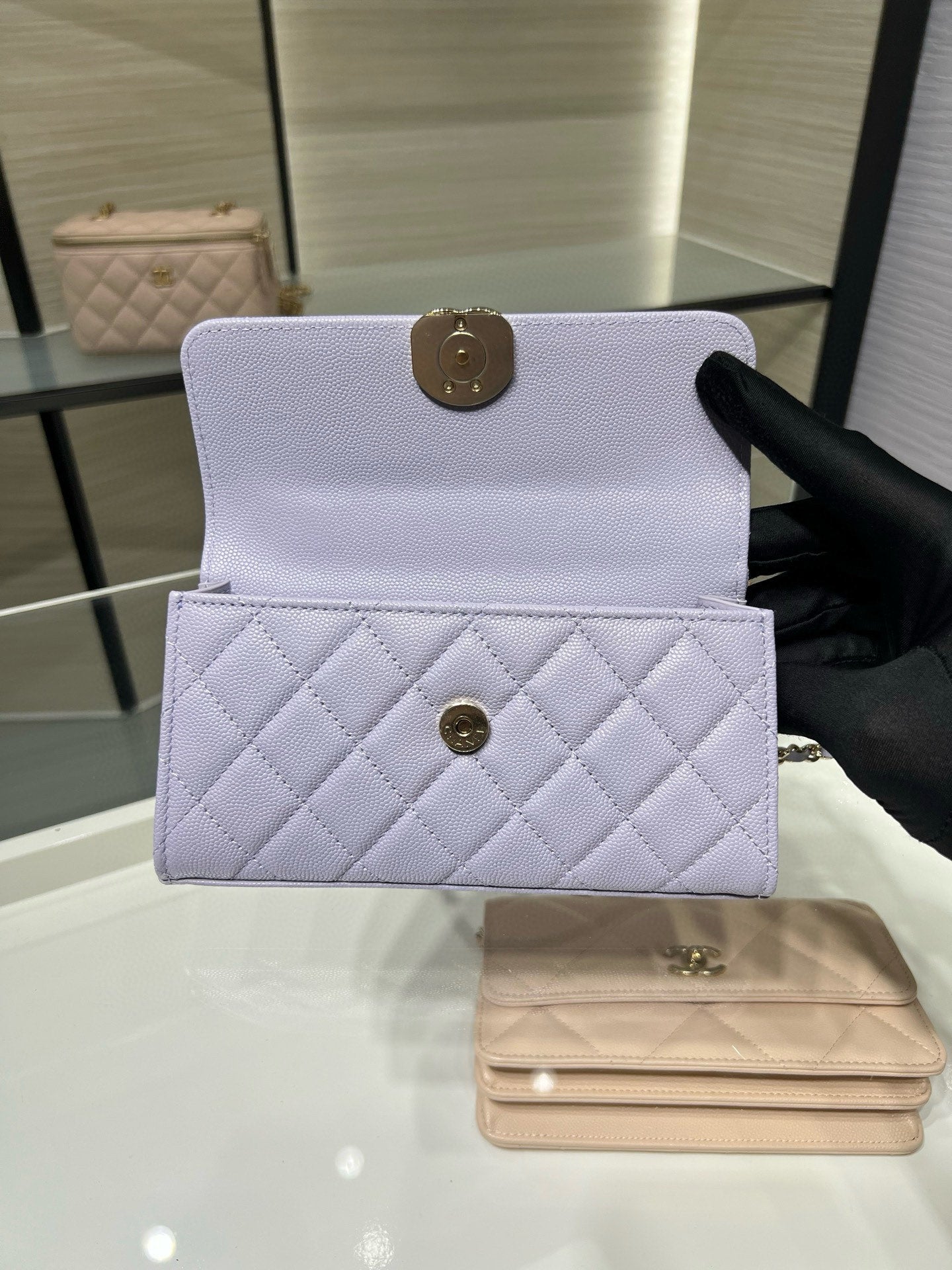 Lavender quilted mini handbag with front flap closure and small front pocket