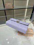 Lavender quilted clutch-style handbag with chain strap and top flap