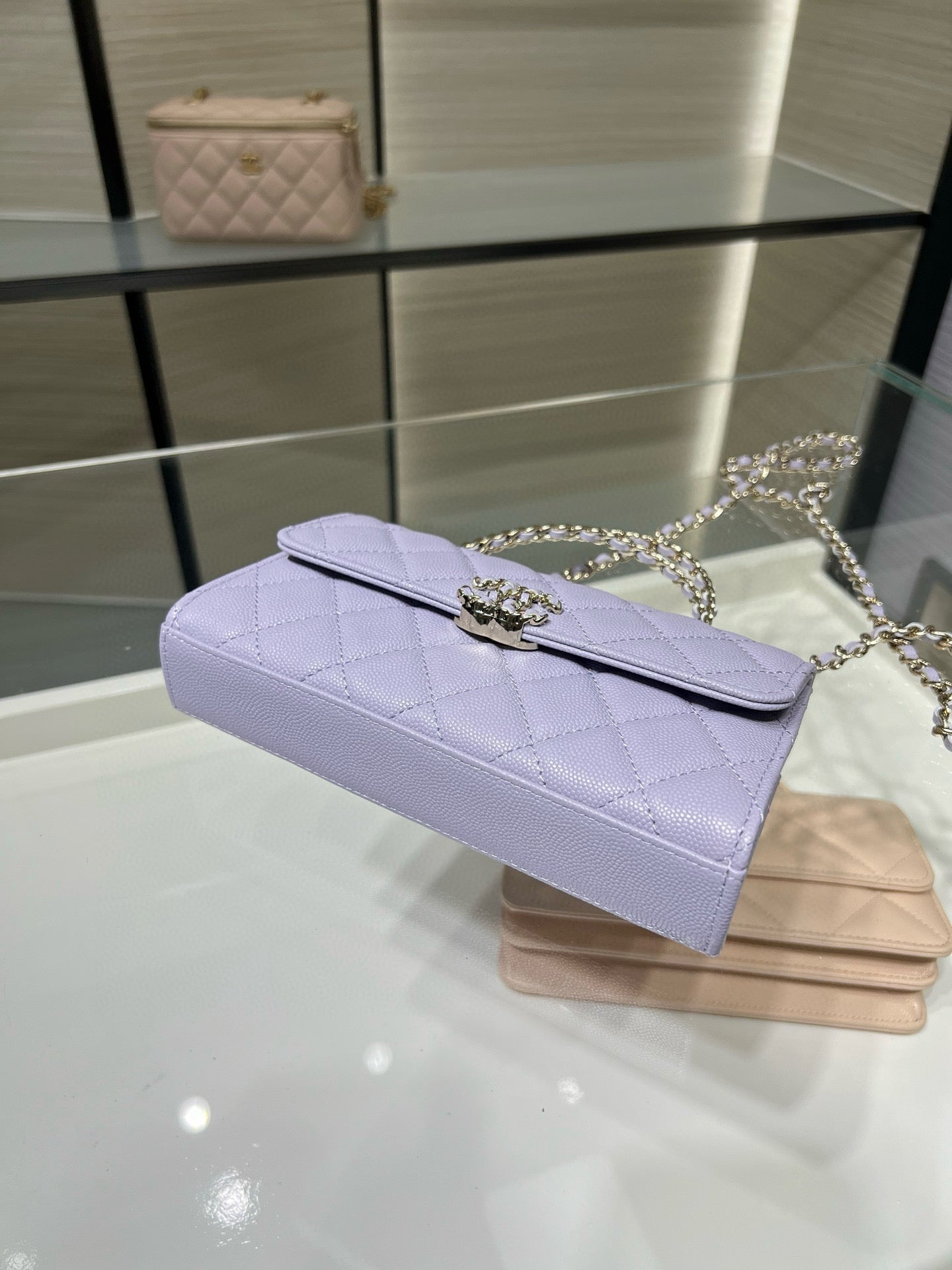 Lavender quilted clutch-style handbag with chain strap and top flap