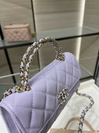 Lavender quilted mini handbag with chain shoulder strap, side angle view