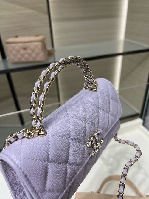 Lavender quilted mini handbag with chain shoulder strap, side angle view