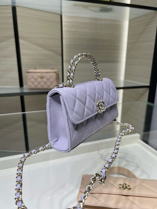 Lavender quilted mini handbag with curved flap and silver chain shoulder strap