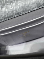 Lavender leather handbag with textured grain and gold logo stamping on interior flap