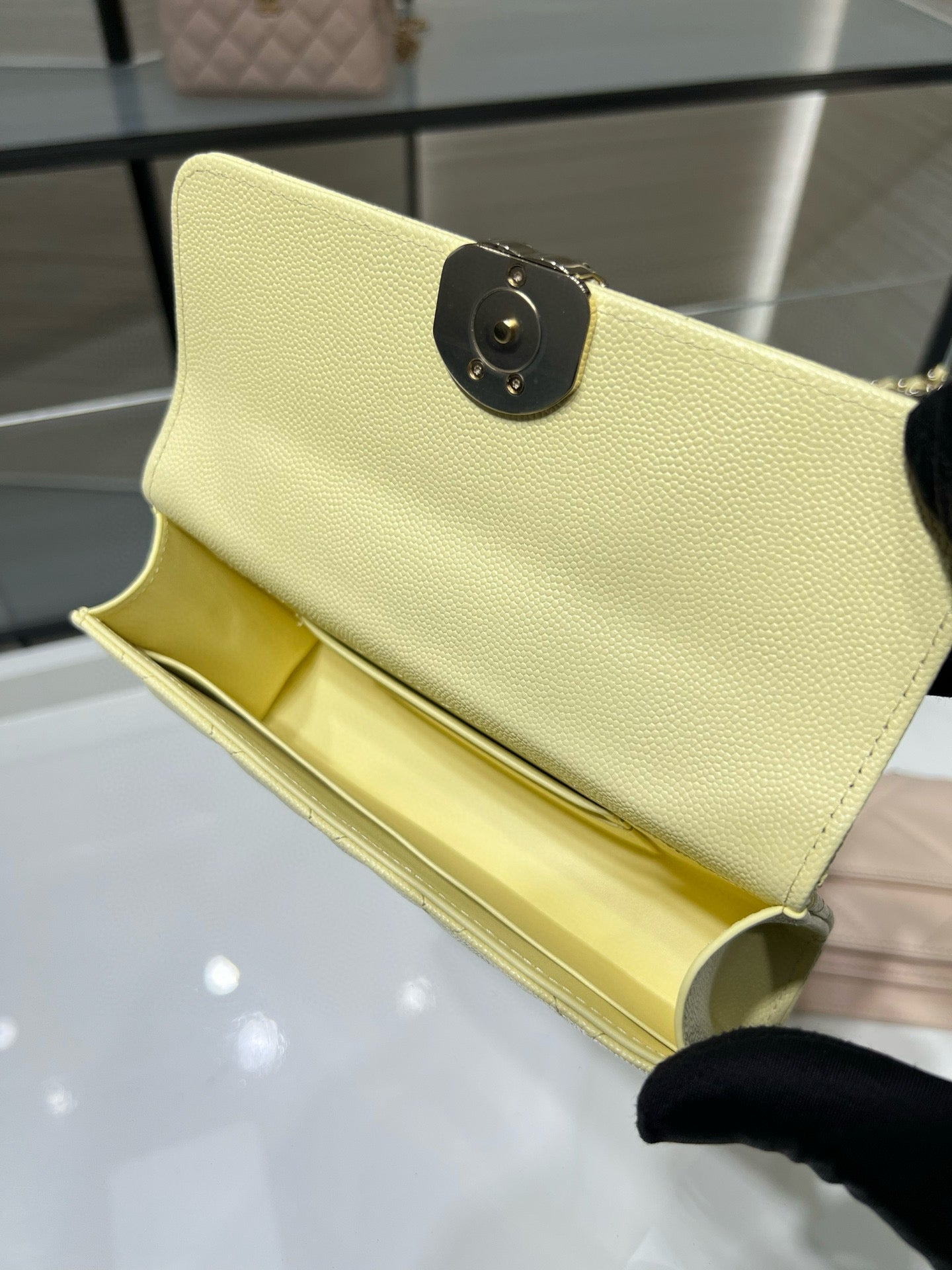 Chanel small crossbody bag with black circular turn-lock, light yellow leather interior