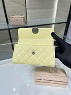 Chanel flap handbag with quilted front and gold hardware, light yellow leather, compact