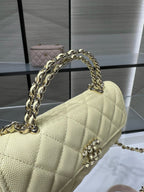 Chanel handbag with gold chain shoulder strap and diamond quilting, light yellow leather