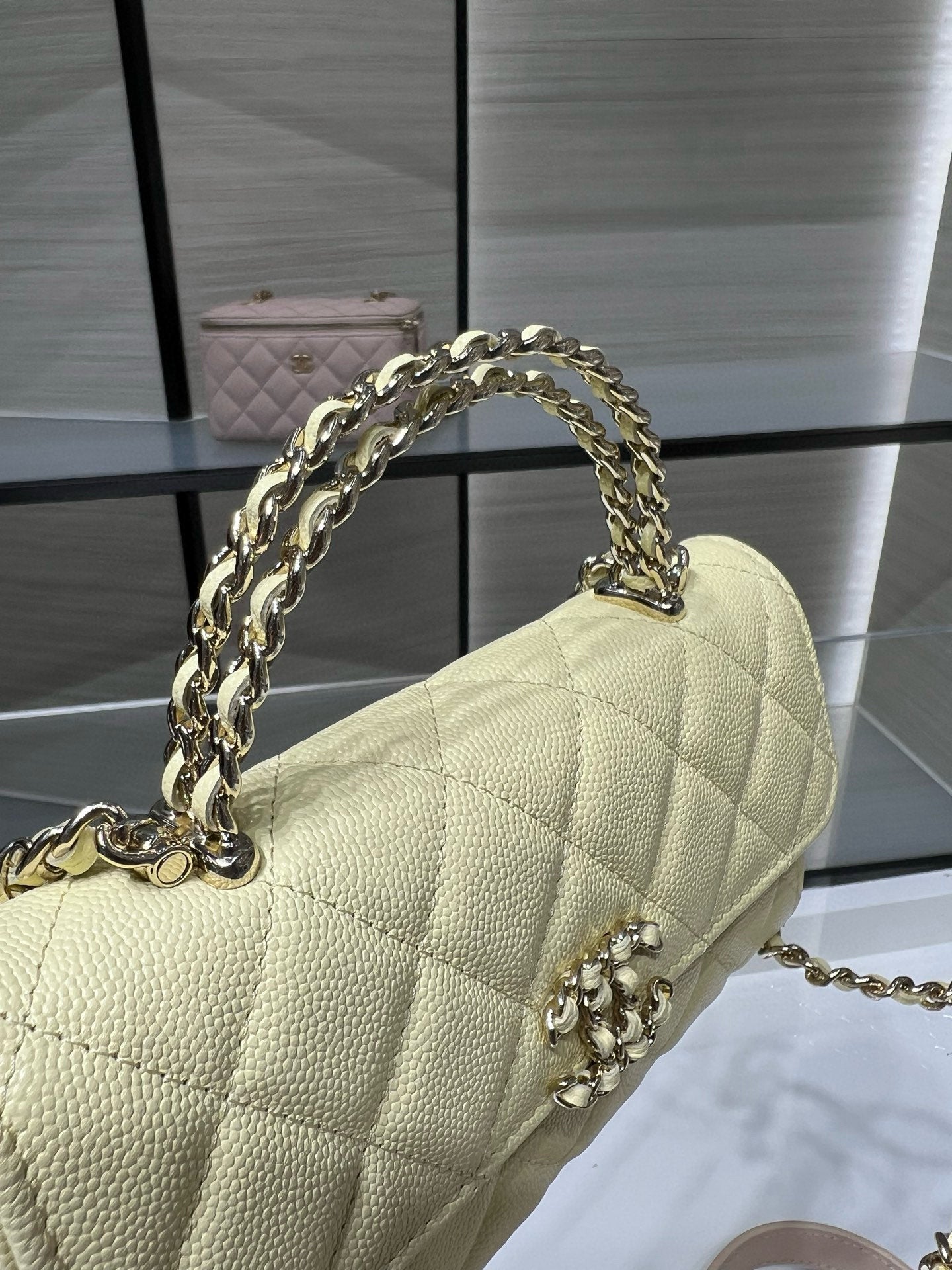 Chanel handbag with gold chain shoulder strap and diamond quilting, light yellow leather
