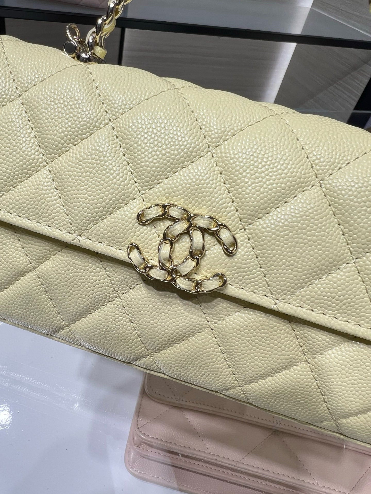 Quilted Chanel flap bag with CC-style turn-lock, light yellow textured leather