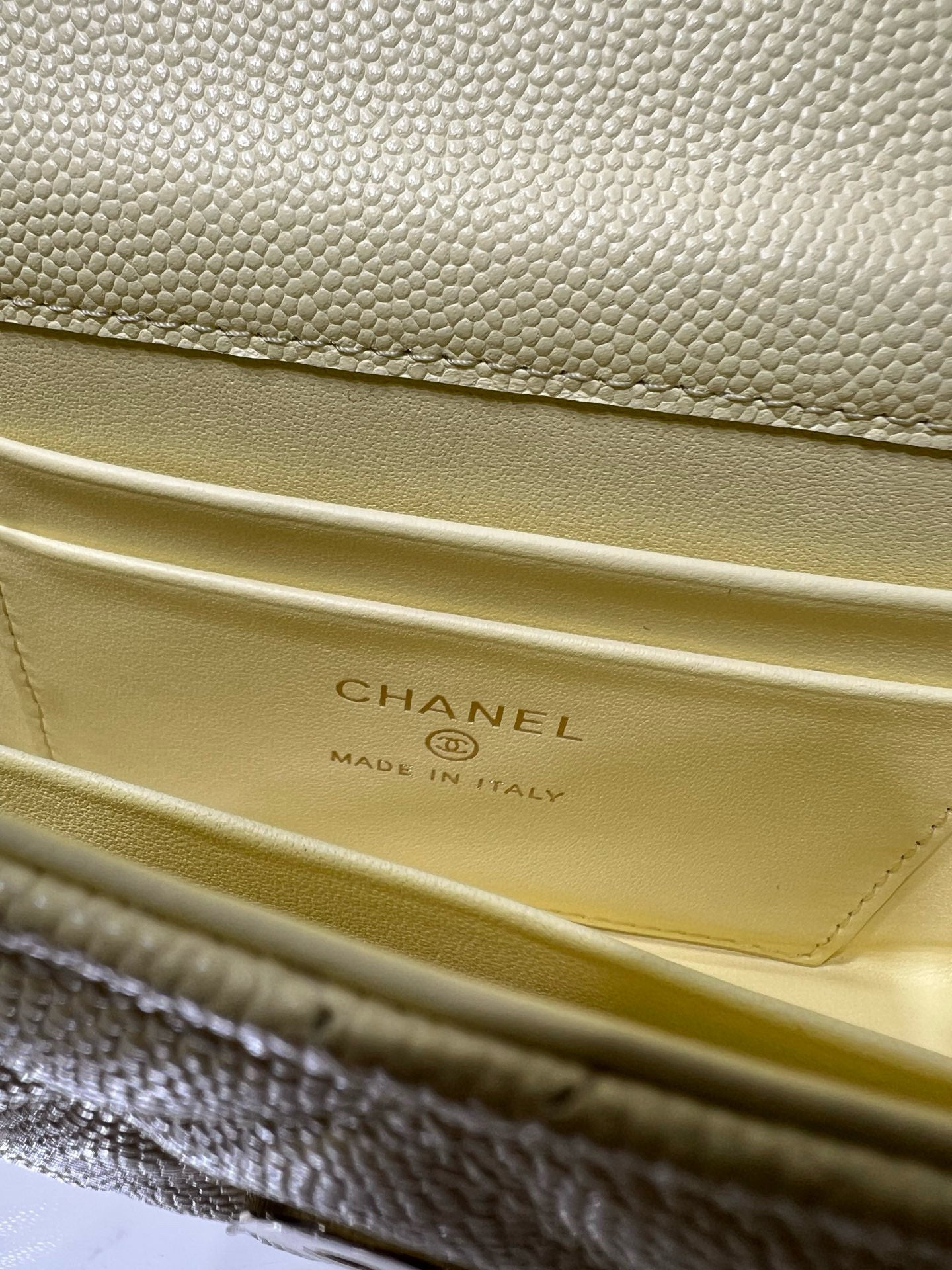 Chanel logo and Made in Italy stamp on light yellow leather flap interior lining
