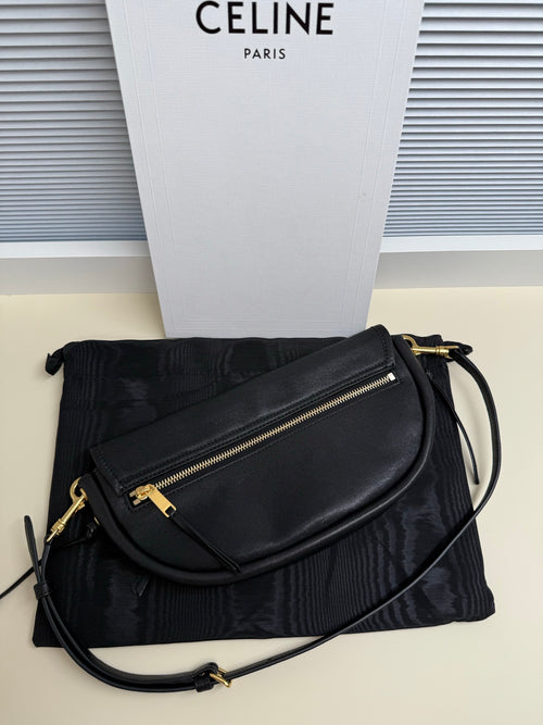 Black Celine crossbody bag with front zip pocket and braided shoulder strap