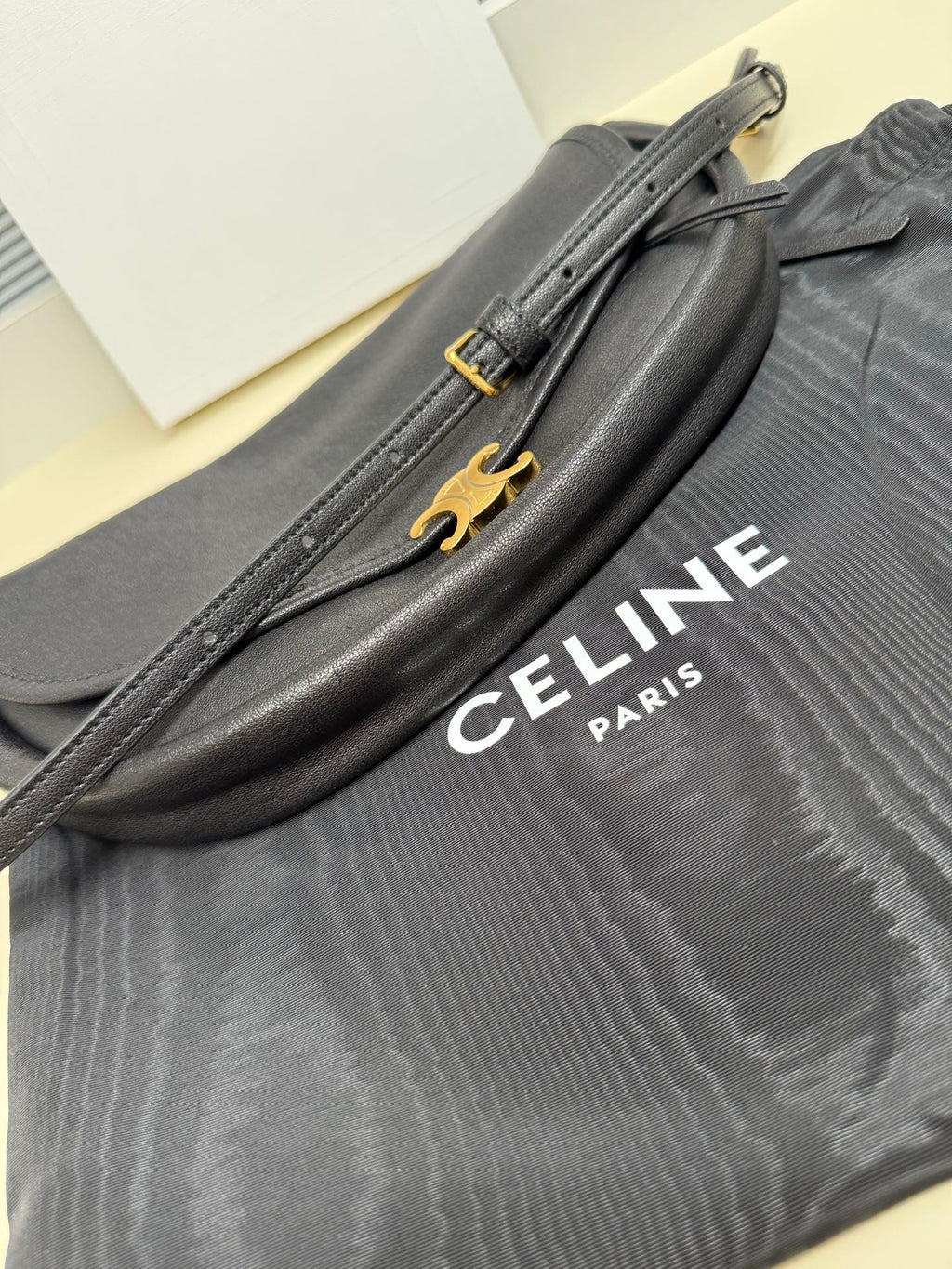 Grey Celine shoulder bag with gold front hardware and logo lettering