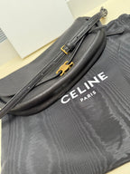 Grey Celine shoulder bag with gold front hardware and logo lettering
