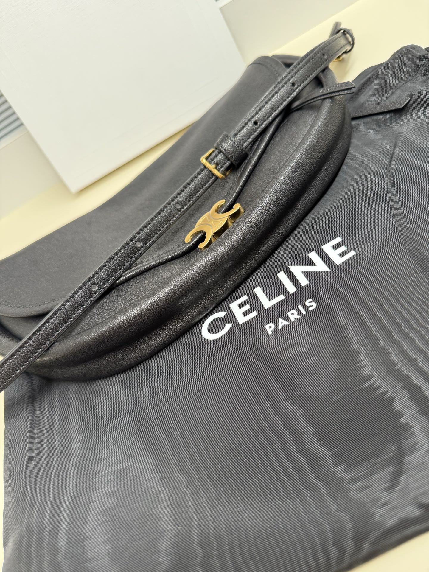 Grey Celine shoulder bag with gold front hardware and logo lettering