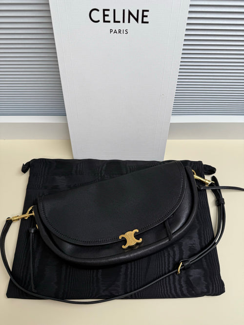 Black Celine flap shoulder bag with gold logo clasp and black crossbody strap