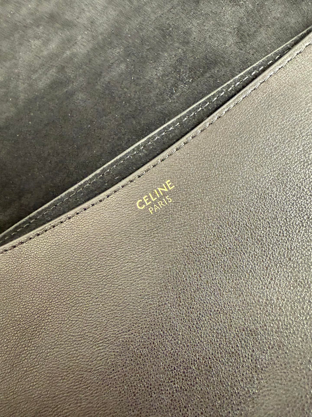Celine Paris stamped on beige leather trim along bag seam