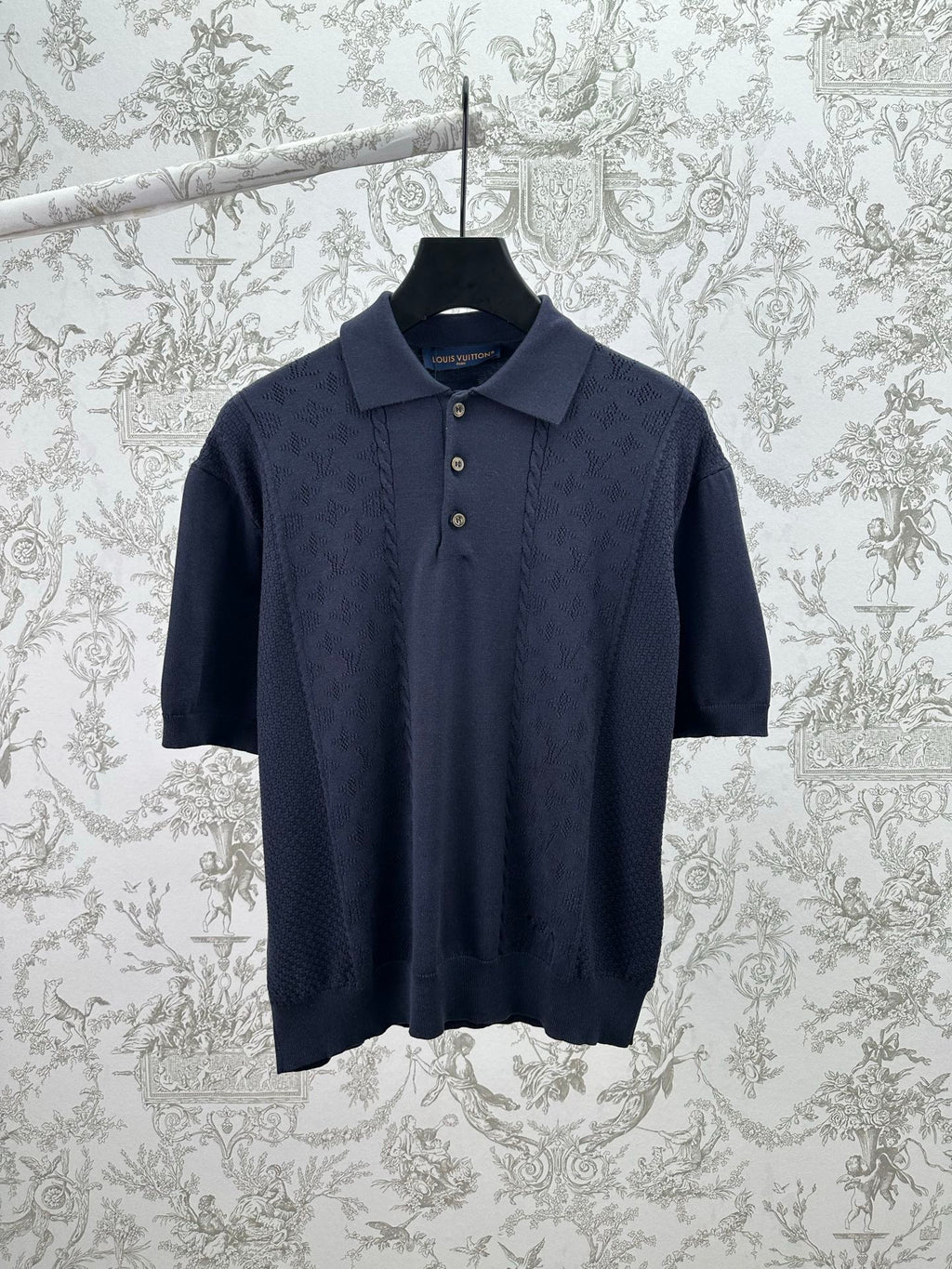 Navy knit polo shirt with button placket and short sleeves