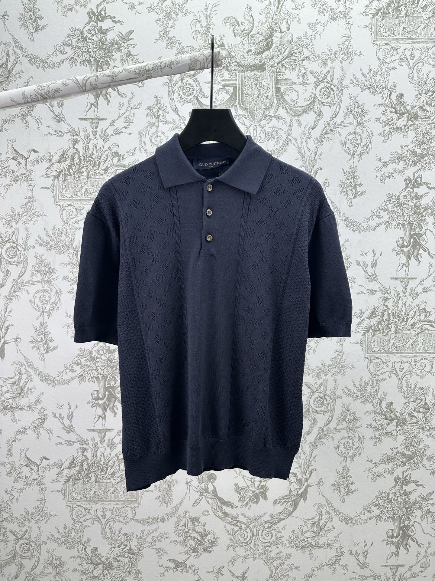 Navy knit polo shirt with button placket and short sleeves