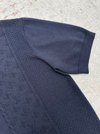Navy knit polo sleeve with textured fabric and ribbed cuff
