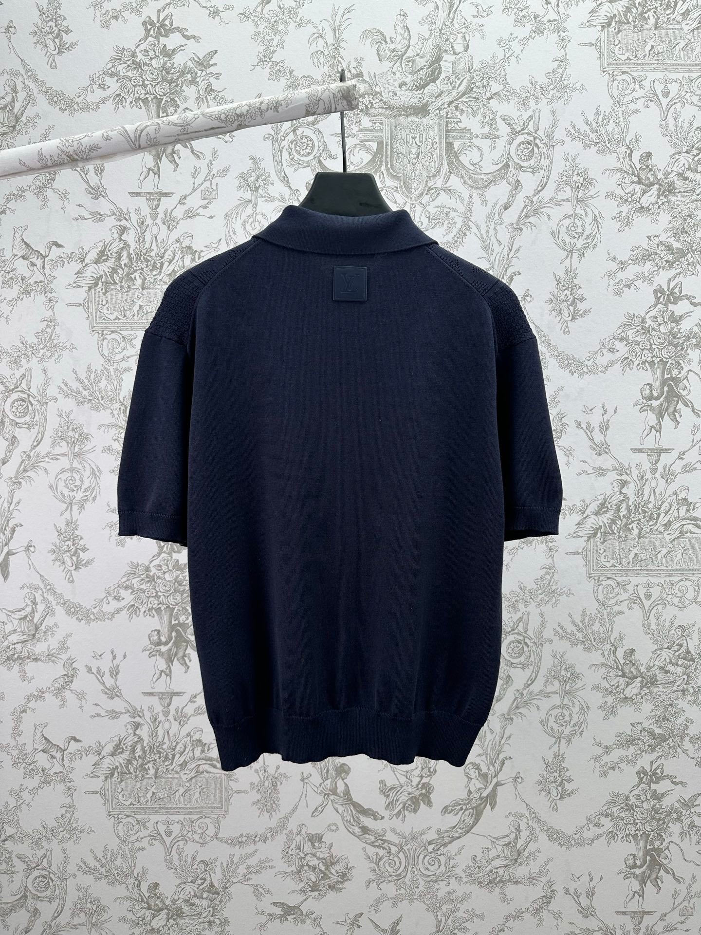 Navy knit polo shirt with ribbed collar and straight hem