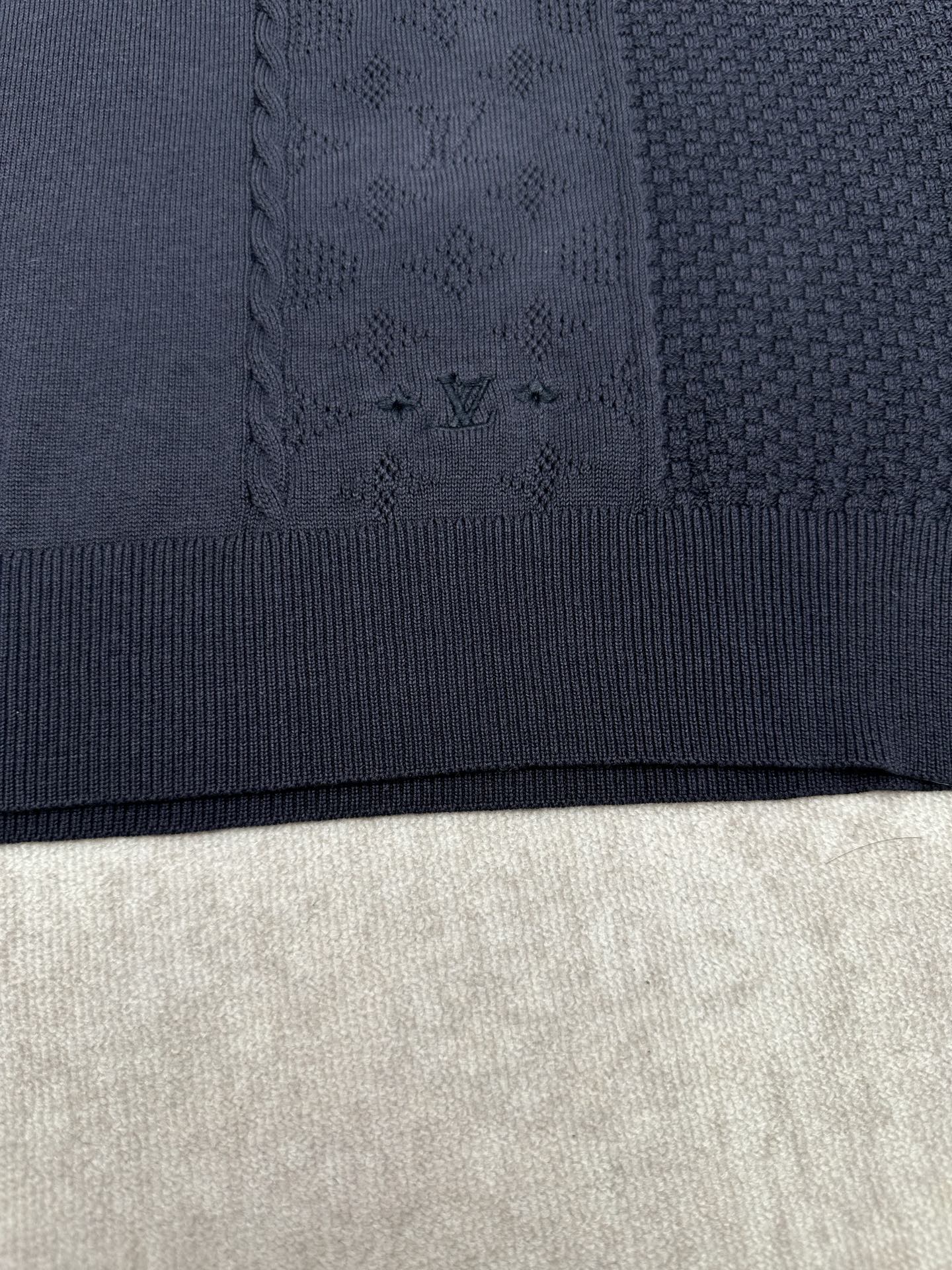 Navy knit polo fabric with textured pattern and ribbed hem band