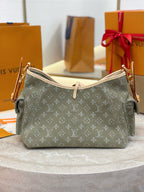 Louis Vuitton monogram shoulder bag, olive-gray canvas with tan handles and side straps.