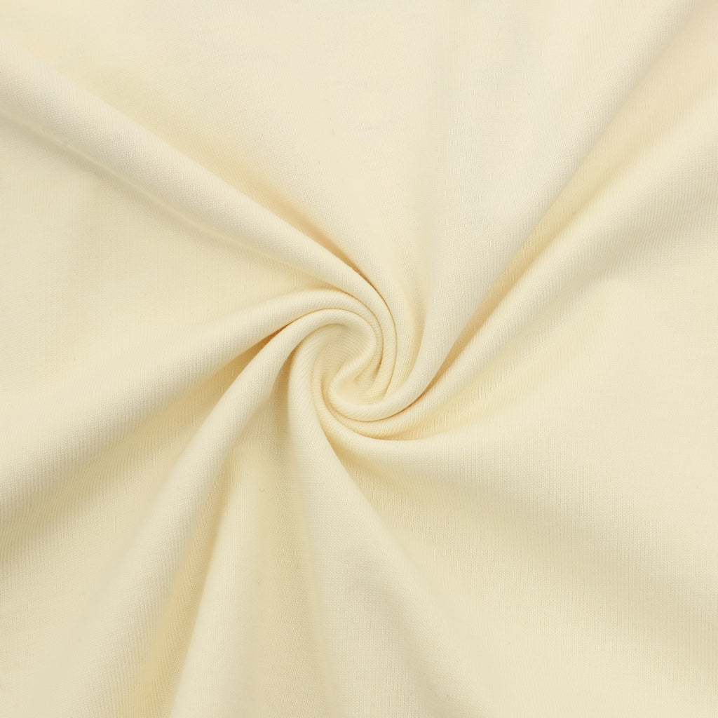 Cream knit T-shirt fabric close-up with smooth texture