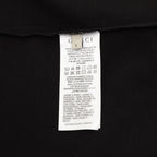 Black T-shirt care label tag on inside neck seam