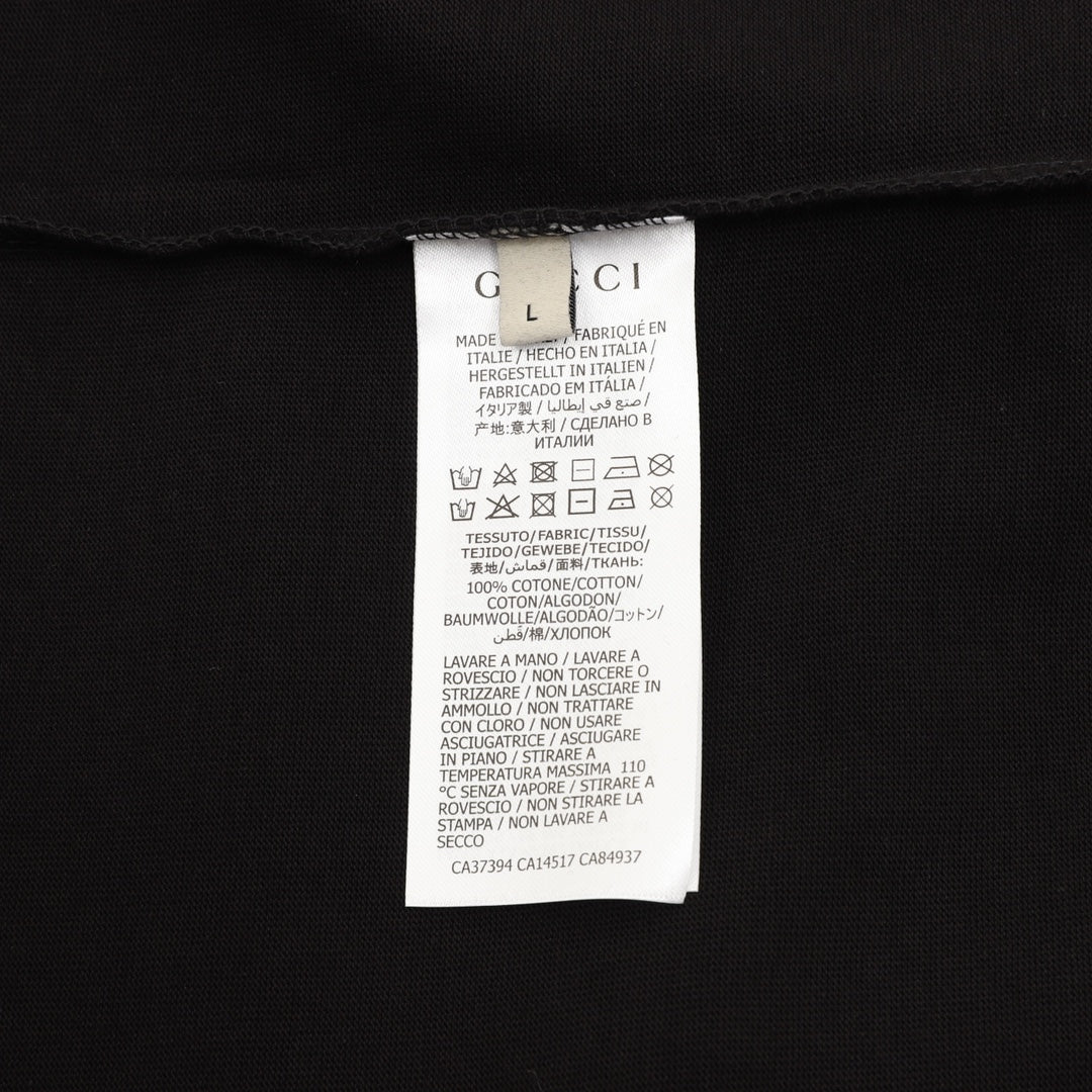 Black T-shirt care label tag on inside neck seam