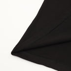 Black T-shirt hem and stitching detail on folded fabric