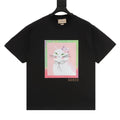 Black T-shirt with colorful cat face graphic on front and Gucci logo near hem