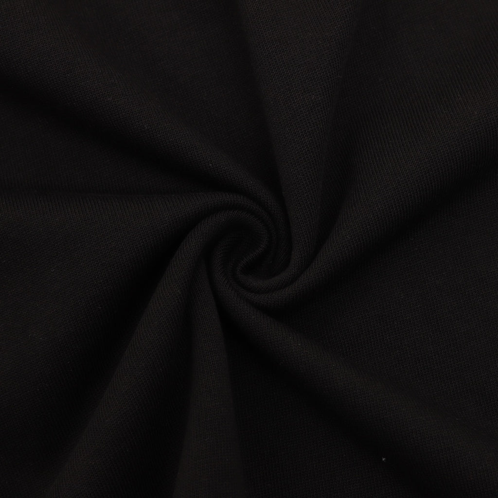 Black T-shirt fabric close-up with textured knit surface